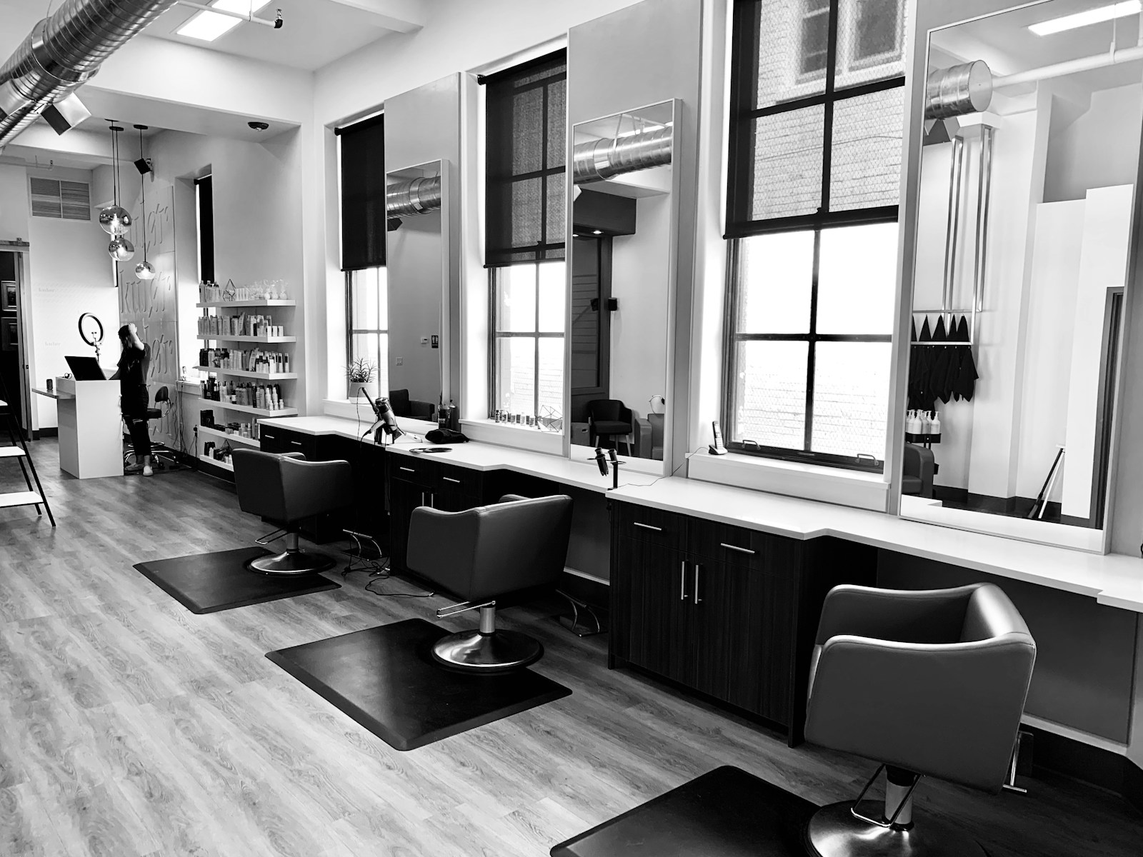 A welcoming salon interior with styling stations and mirrors