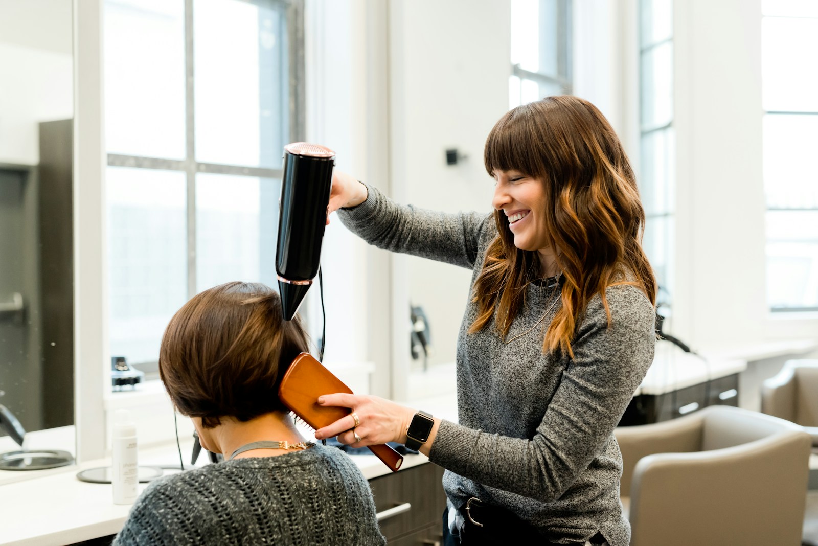 A stylist shaping hair with care